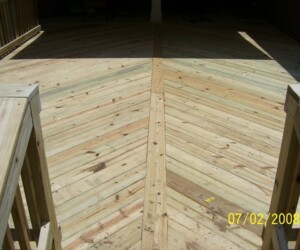 Wooden patio deck with a chevron pattern and railings on either side, dated July 2, 2008.