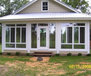 A small house with a white sunroom and large windows on a grassy lawn, dated 09/11/2008.